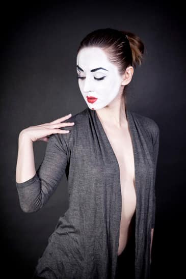 female mime on black background