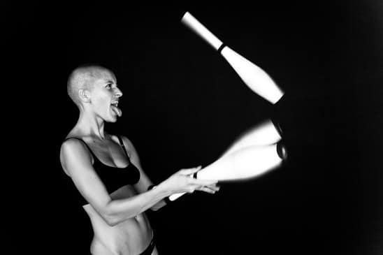 Bald-headed girl juggles
