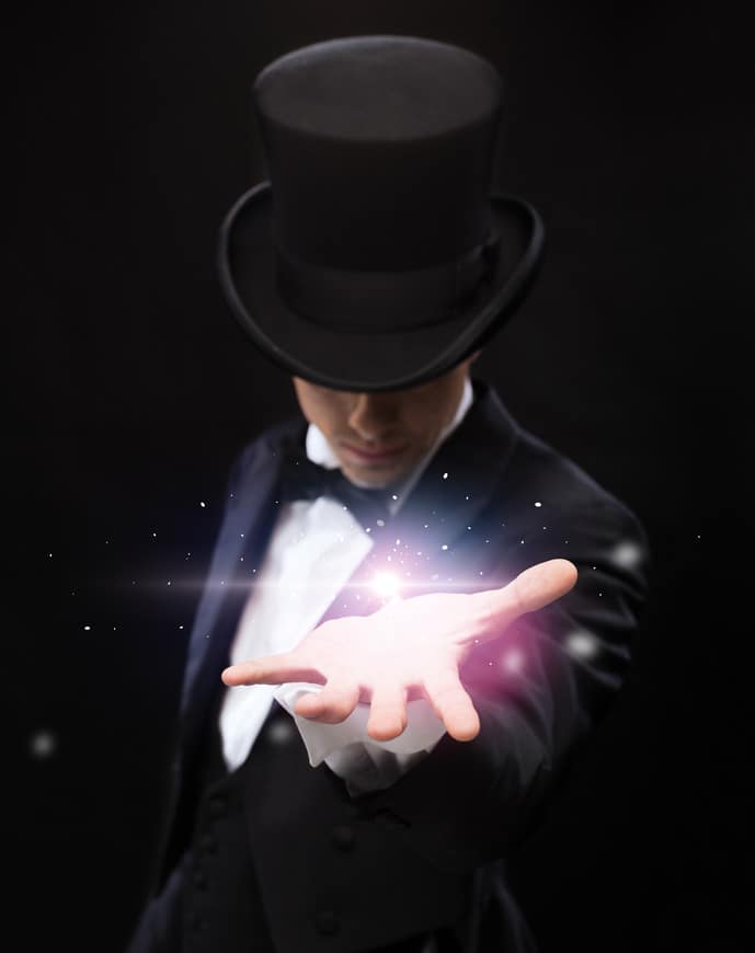 magician holding something on palm of his hand